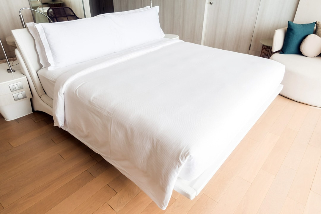 bed with white duvet and pillow covers