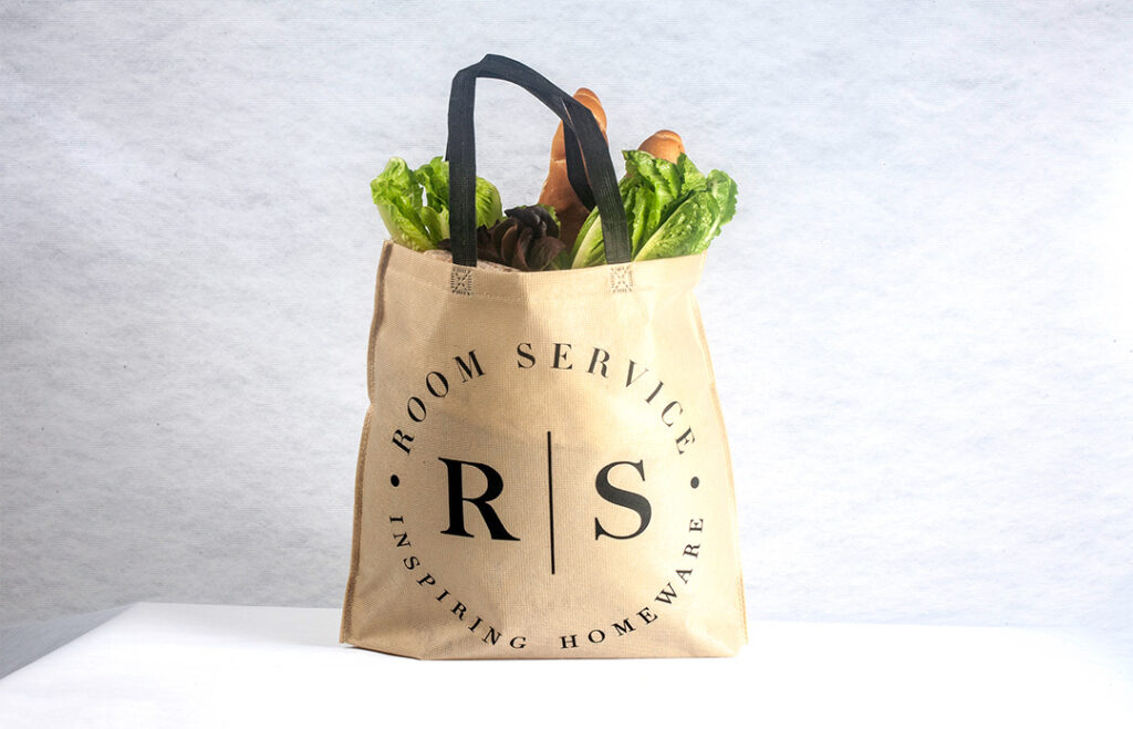 stitch-bonded non-woven material shopping bag with carrots and lettuce inside it