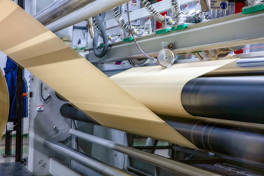 Stitch-bonded non-woven material rolling off the manufacturing equipment at Romatex
