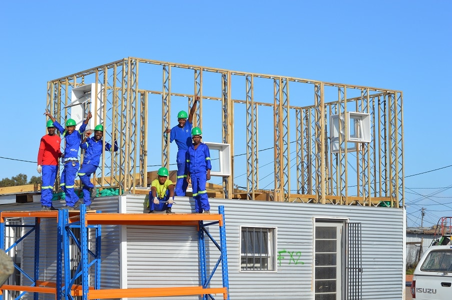 Possibilities of eco-bricks in South Africa 16 Builders erecting a house with eco-bricks and steel.