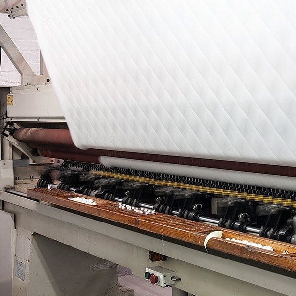 Home linen coming off a machine at Romatex textile industry