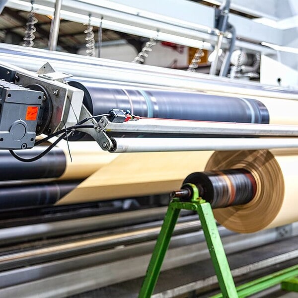 A roll of stitchbond textile being wound onto a spool at a local textile supplier facility in Cape Town, South Africa