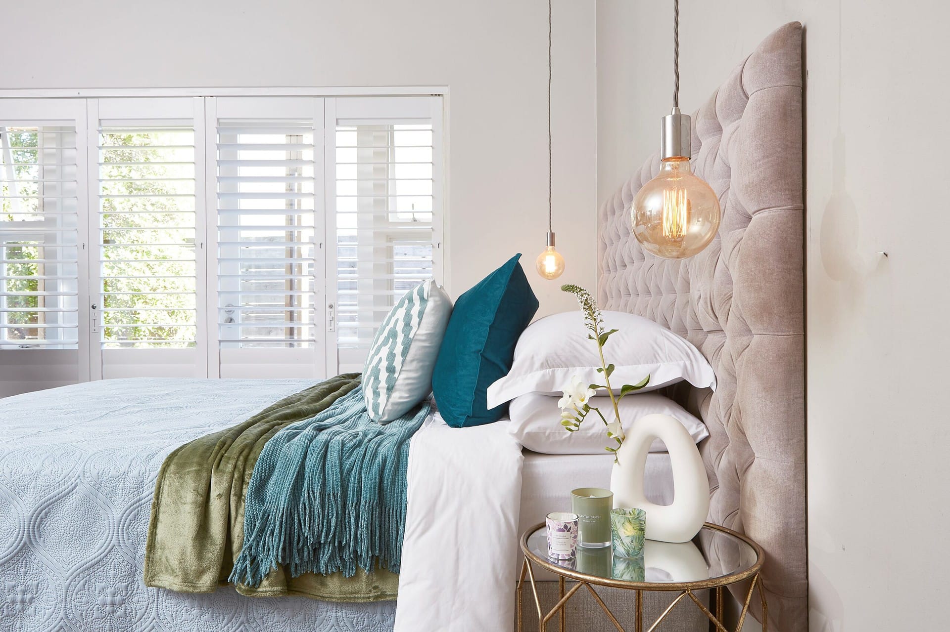 Bed linen fabrics and homeware on a bed