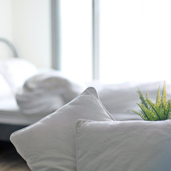 White pillows and bed linen in a light bedroom